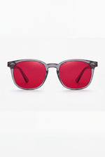Wavelength Night Lens — red-tint blue light glasses, front view on white