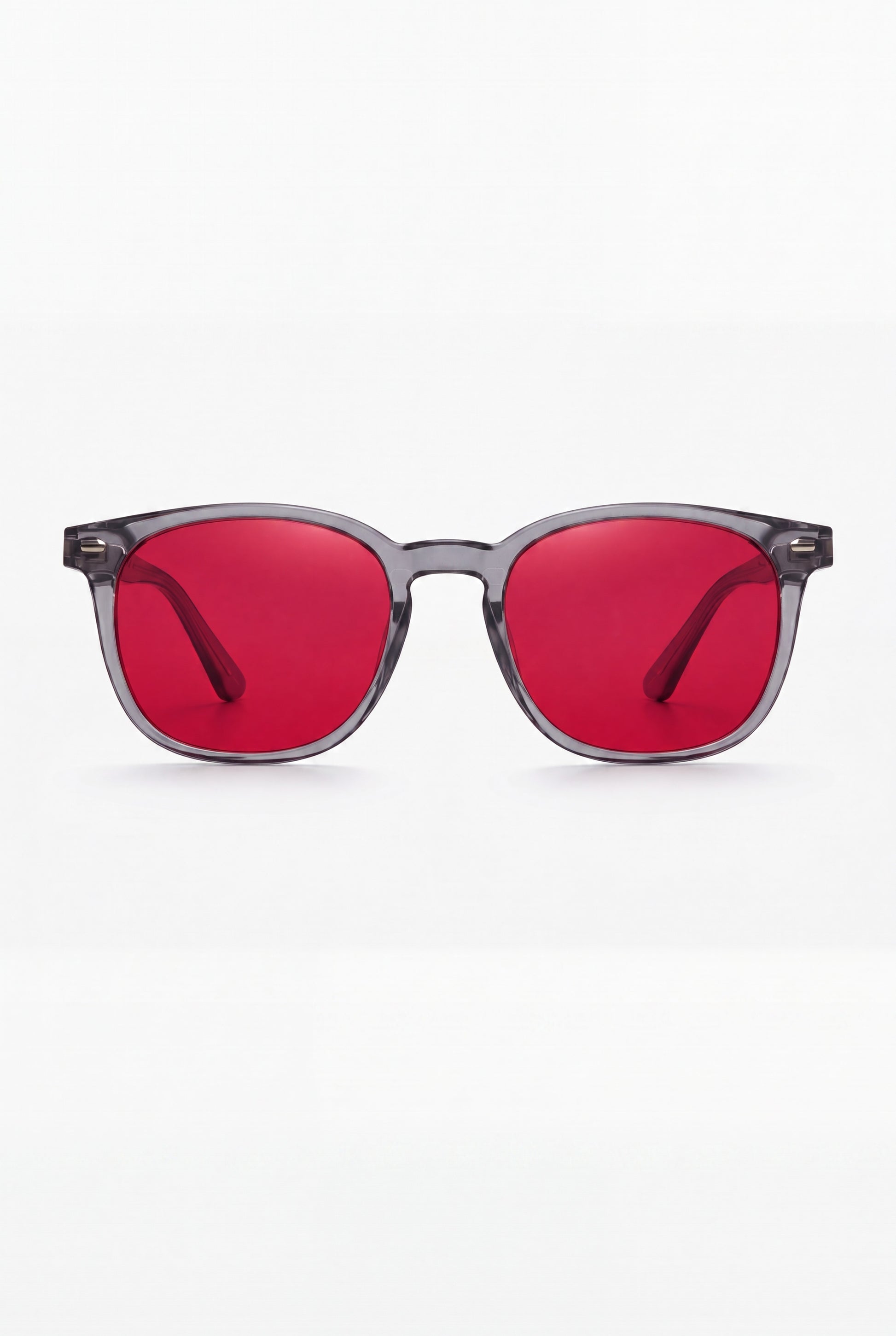 Wavelength Night Lens — red-tint blue light glasses, front view on white
