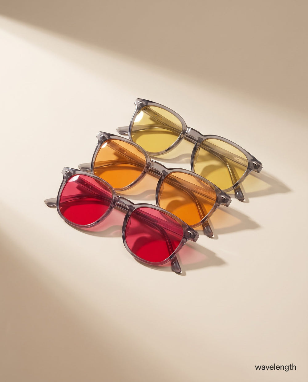 The three Wavelength lenses in yellow, orange and red, fanned out in warm light